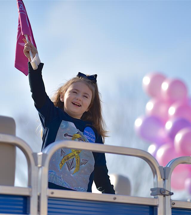 Lana holding her flag on her new boat